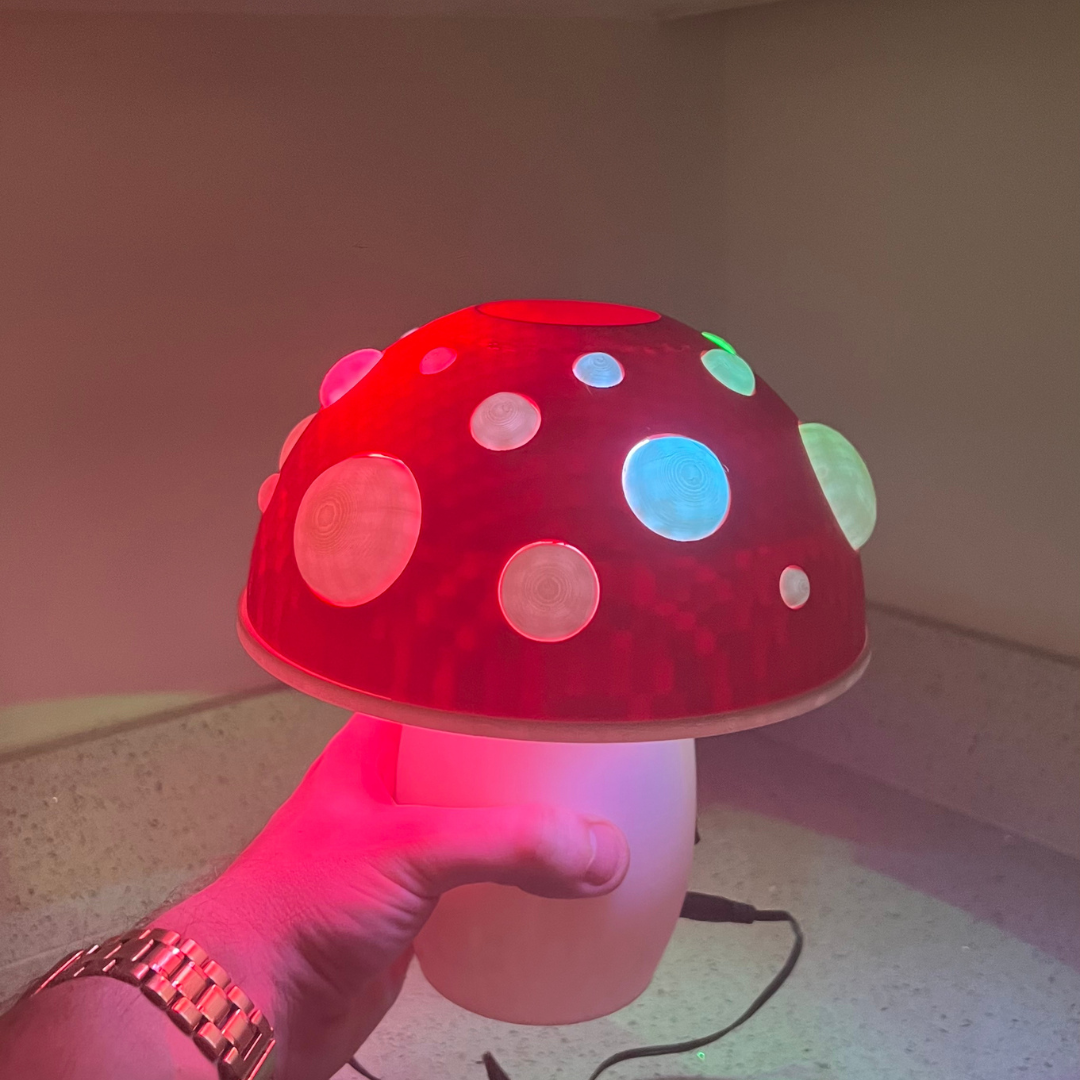 mushroom lamp with a red cap and colorful glowing spots, perfect for adding a fun touch to any room.