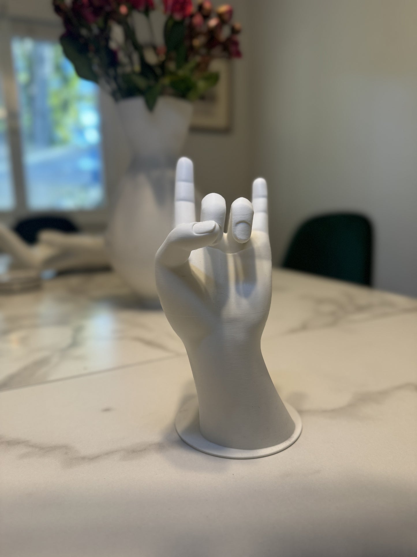 Decorative jewelry stand in the shape of a hand, providing a chic and functional solution for organizing rings, necklaces, and bracelets.