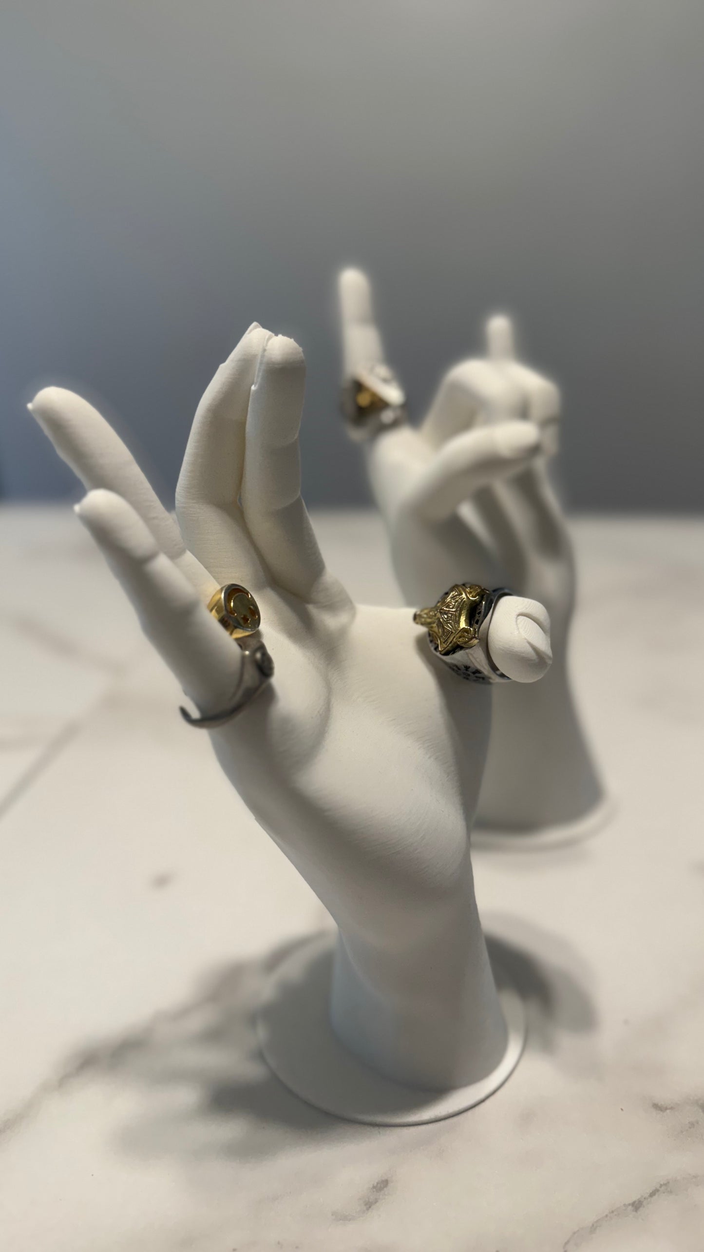 Minimalist hand-shaped jewelry organizer with smooth surfaces, perfect for showcasing rings, bracelets, and necklaces on a vanity.