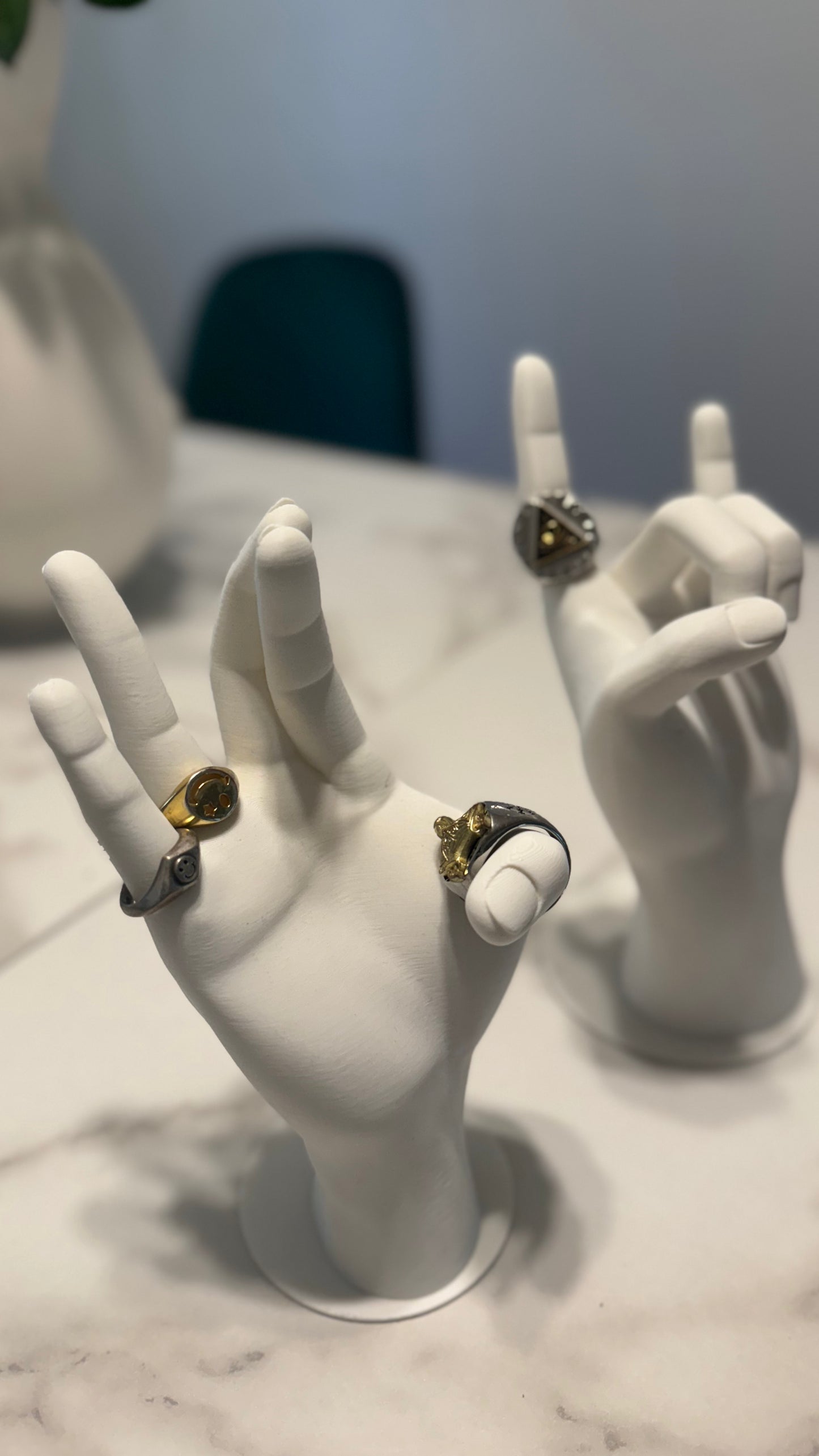 The Jewelry Hand Stand holding rings and bracelets, demonstrating how it securely displays various jewelry pieces.