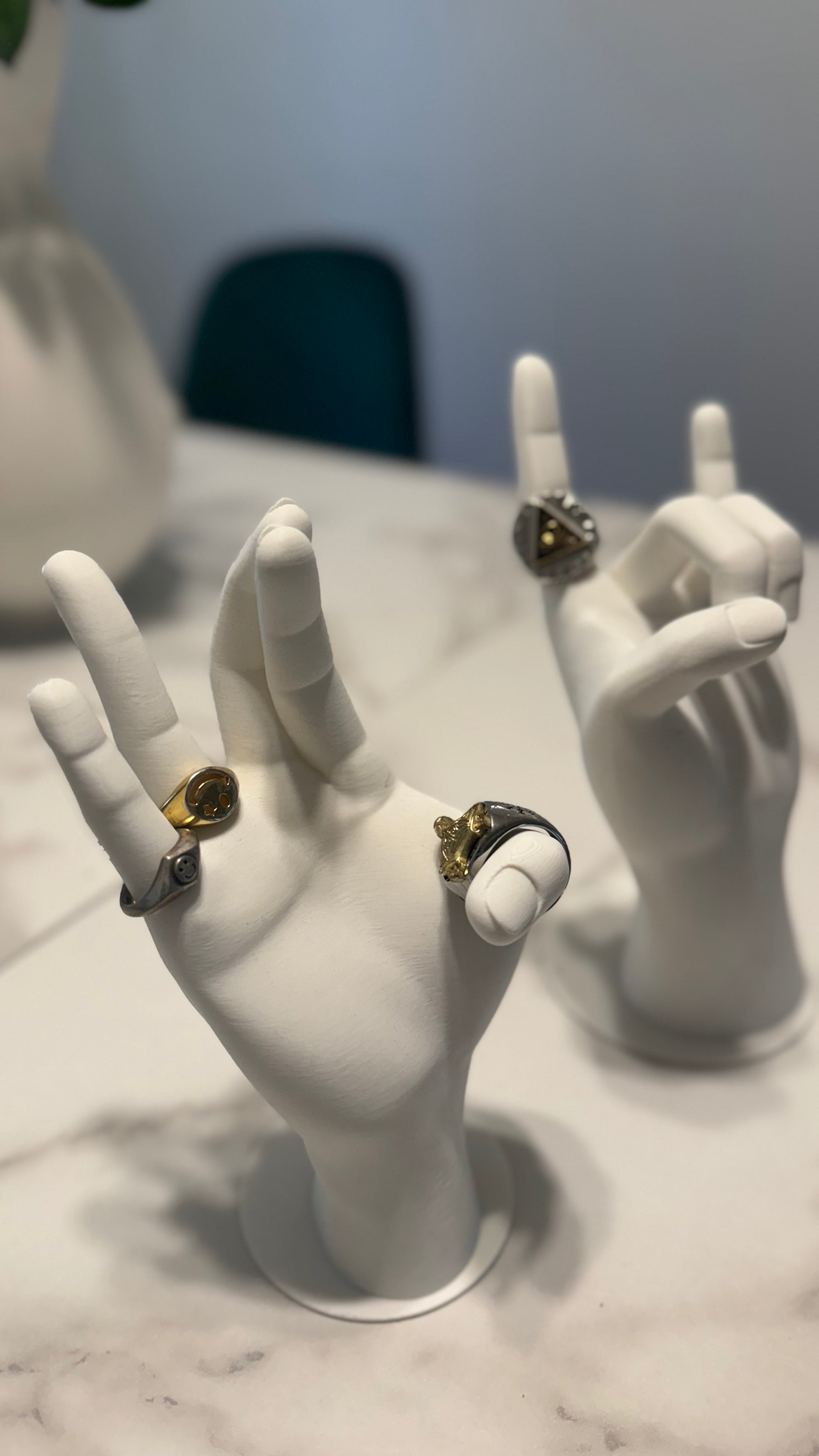 The Jewelry Hand Stand holding rings and bracelets, demonstrating how it securely displays various jewelry pieces.